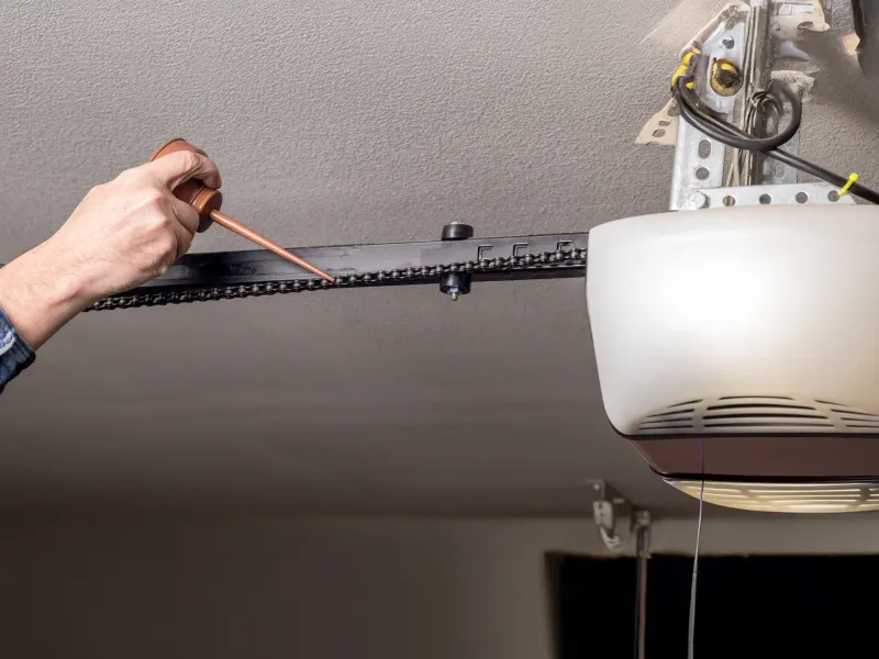 Technician installing garage door opener